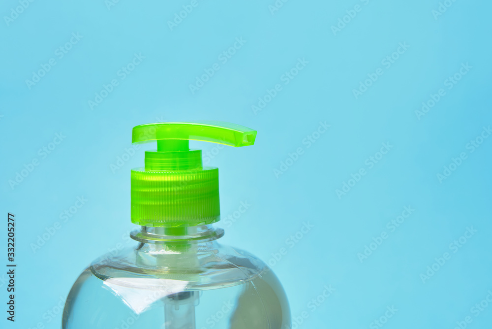 pointer finger on sanitizer antiseptic. health care concept. blue background. copy space. pointer finger on sanitizer antiseptic. health care concept. blue background. copy space.