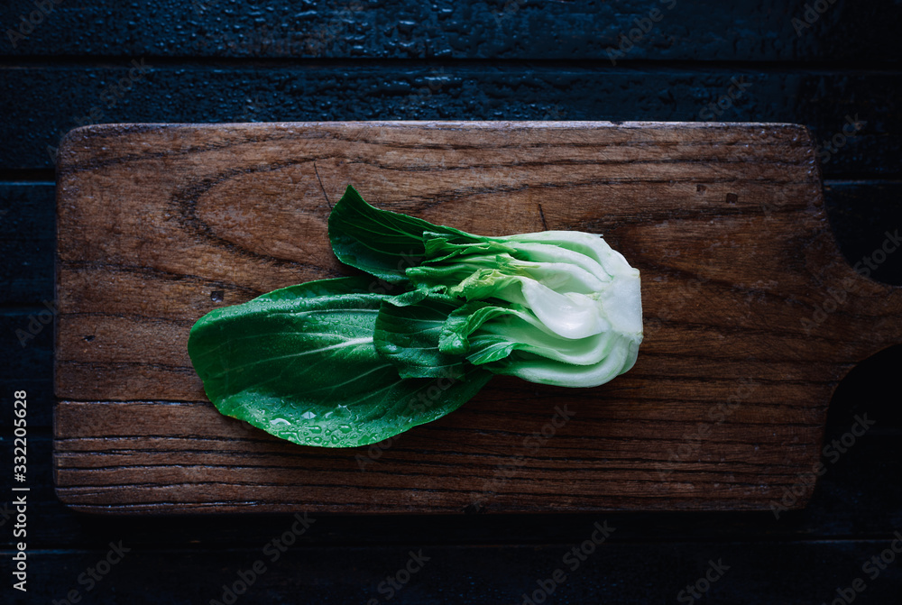 Top view of chinese cabbage pak choy on a wooden board healthy vegan food 