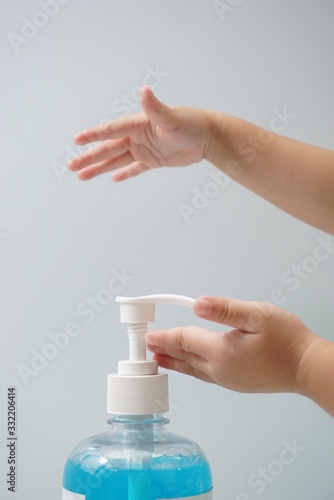Child hand picks soap or sanitizer for personal hygiene measures.
