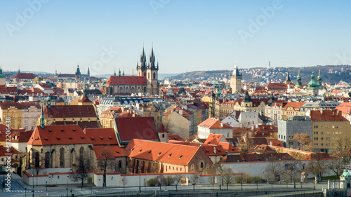 Photography Overall view of Old Town of Prague shortly after sunrise, sunny spring day with blue sky