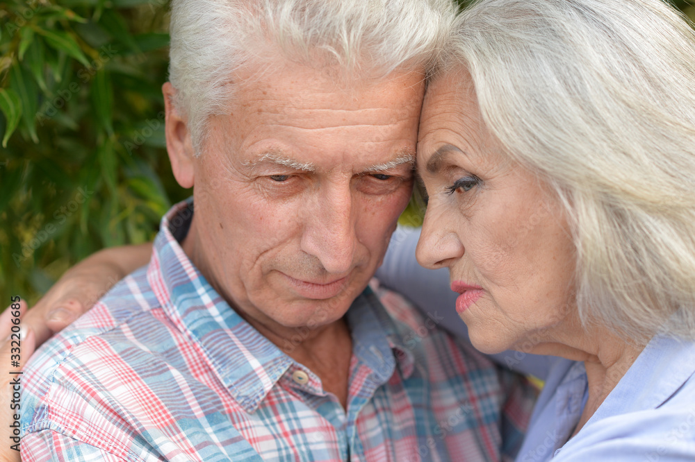 Close up portrait of unhappy senior couple in the park Close up portrait of unhappy senior couple in the park