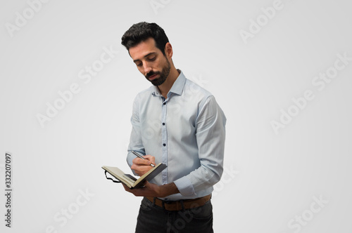 Attractive man taking notes in a notebook