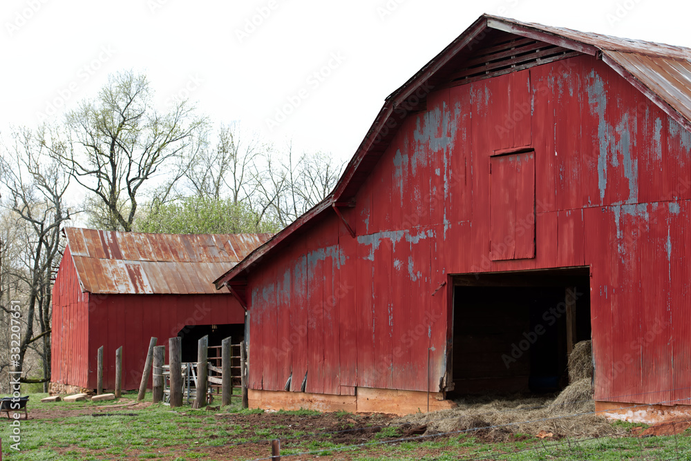 A traditional red barn on a large farm. A traditional red barn on a large farm.