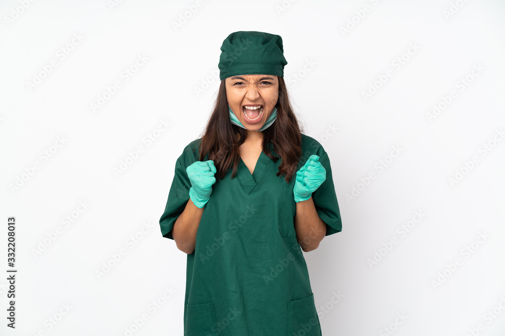Surgeon woman in green uniform isolated on white background celebrating a victory in winner position Surgeon woman in green uniform isolated on white background celebrating a victory in winner position