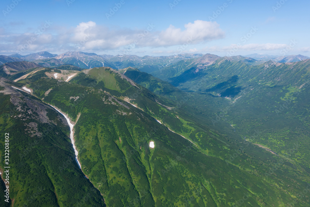 Fototapeta premium aerial view of Kamchatka volcanos, green valleys, snow and ice and the wonderful view of pure nature.
