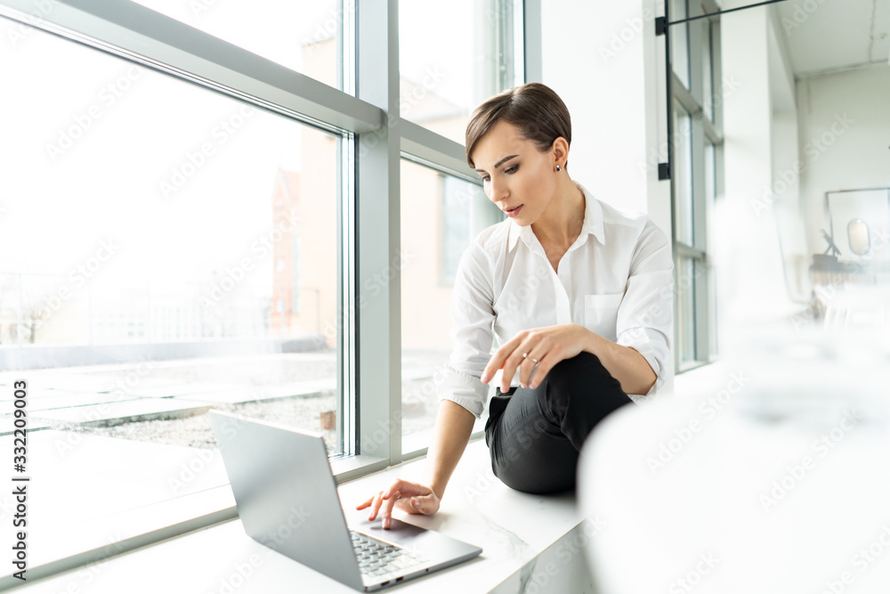 Young businesswoman working on a laptop Young businesswoman working on a laptop