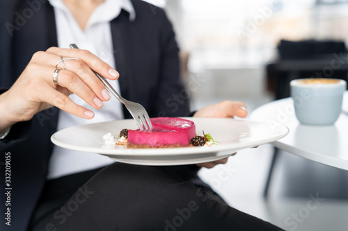 Elegant woman taste cheesecake