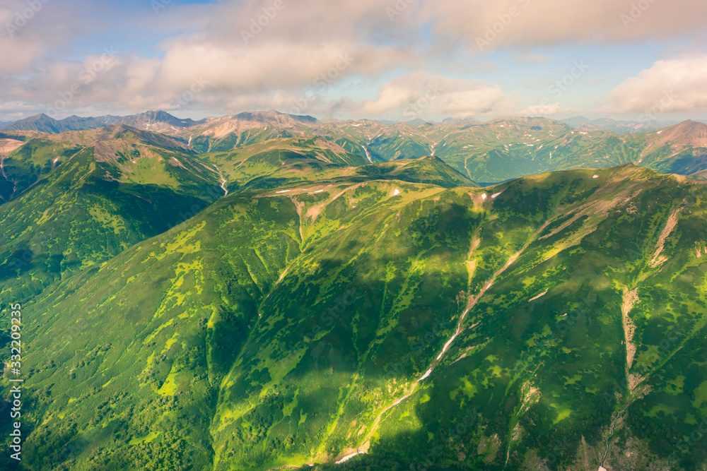 Fototapeta premium aerial view of Kamchatka volcanos, green valleys, snow and ice and the wonderful view of pure nature.