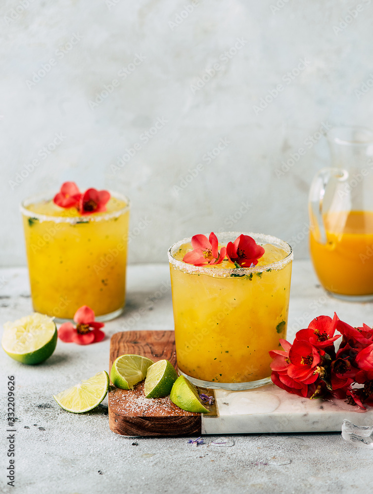 Fresh mango mojiton cocktail with flowers Fresh mango mojiton cocktail with flowers