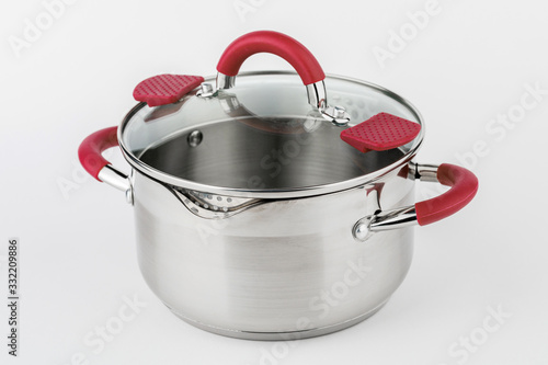 Canvas Print Stainless casserole with glass lid and red handles on grey background