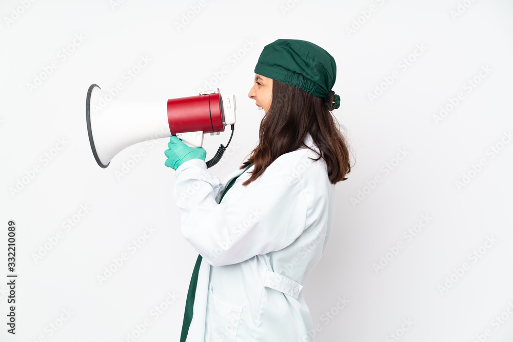 Surgeon woman in green uniform isolated on white background shouting through a megaphone Surgeon woman in green uniform isolated on white background shouting through a megaphone
