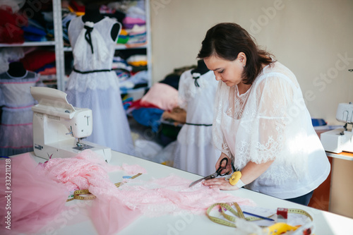 Woman cuts fabric in workshop