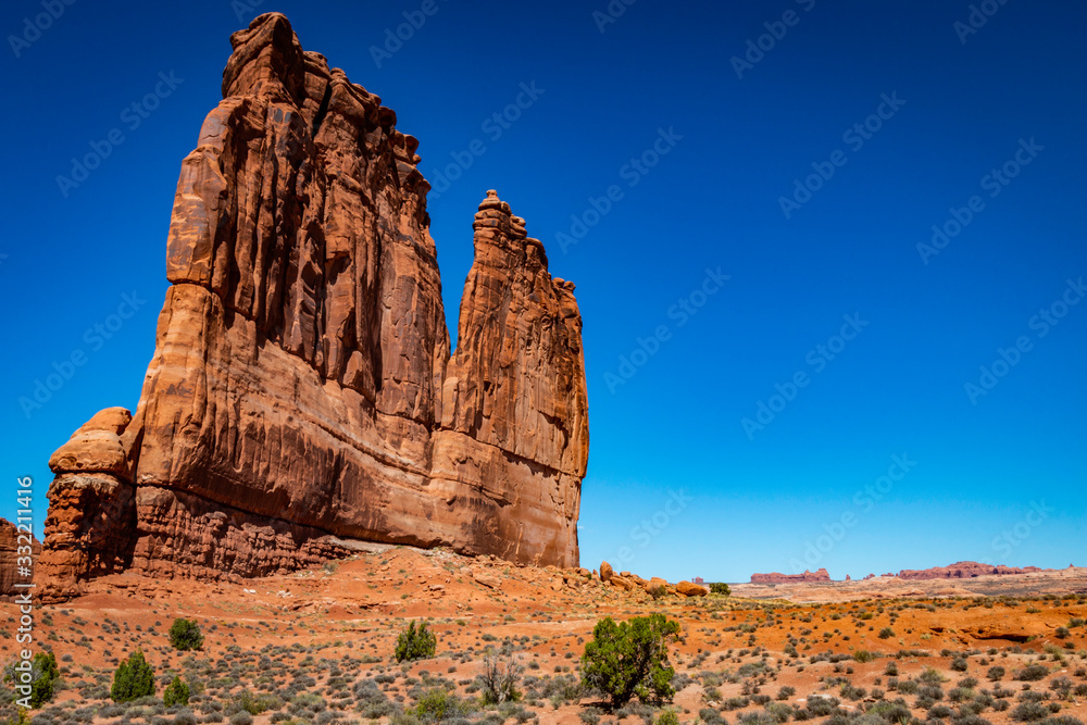 A photo showing the vast scale of The Organ monument in Arches National Park outside of Moab, Utah