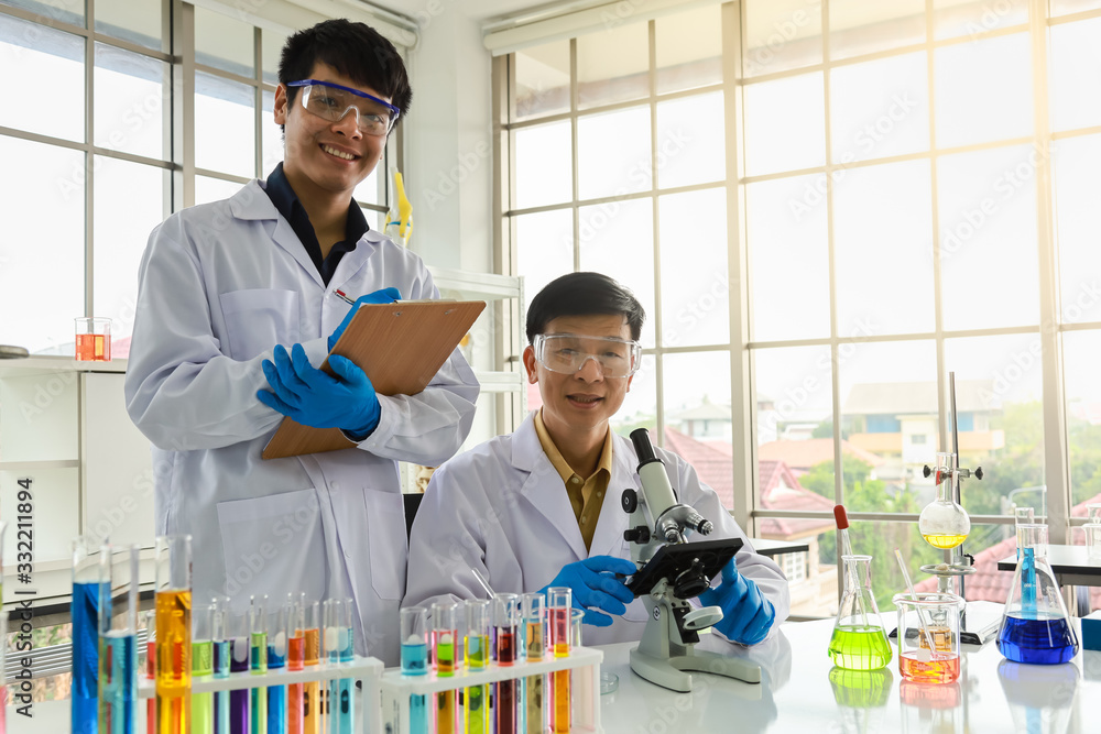 Portrait of two asian professional senior and young doctor scientist working, using microscope and research in working laboratory. Healthcare concept. Portrait of two asian professional senior and young doctor scientist working, using microscope and research in working laboratory. Healthcare concept.
