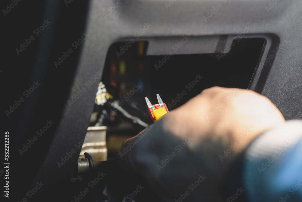 A car fuse replacement close up. A car fuse replacement close up.
