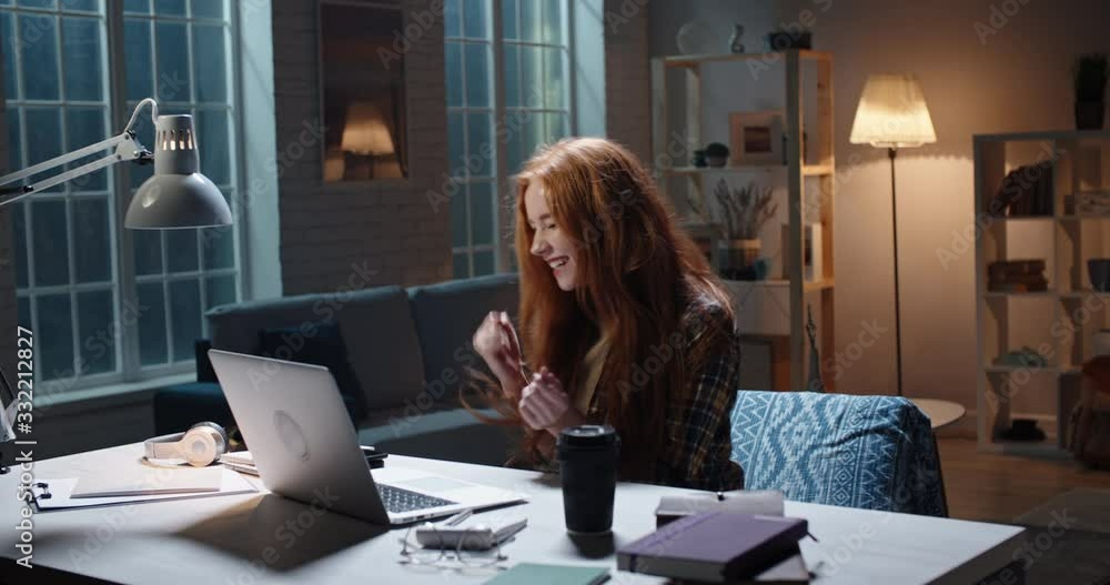 Cute redhead girl surprised by looking at laptop screen, doing a cheerful funny dance, high school student getting a scholarship, young businesswoman winning on stocks market 4k footage Cute redhead girl surprised by looking at laptop screen, doing a cheerful funny dance, high school student getting a scholarship, young businesswoman winning on stocks market 4k footage