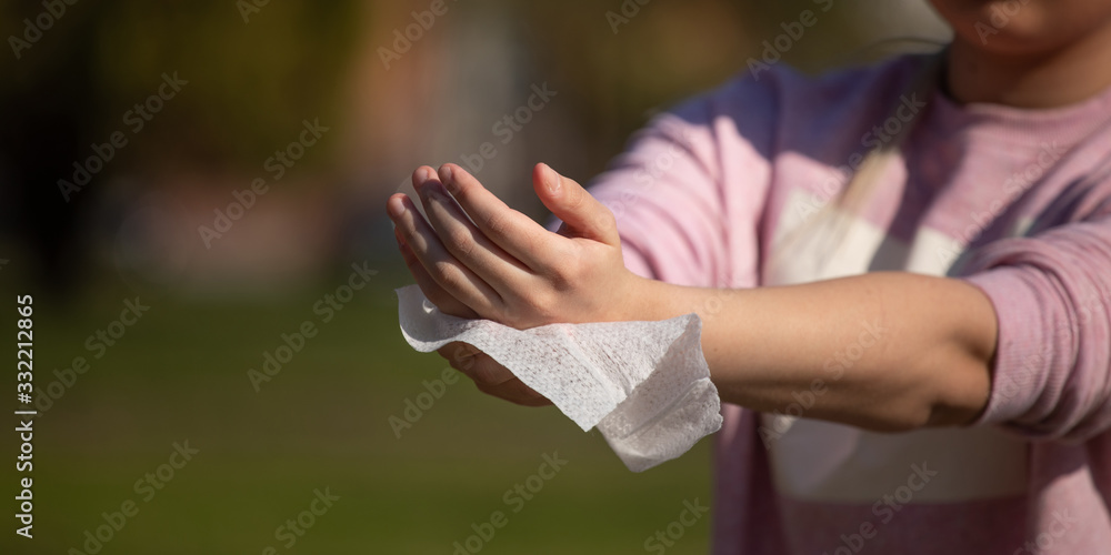Prevention of influenza - Cleaning hands with wet wipes against disease infection like flu or influenza