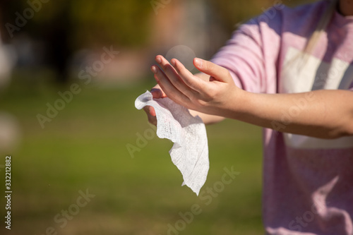 Prevention of influenza - Cleaning hands with wet wipes against disease infection like