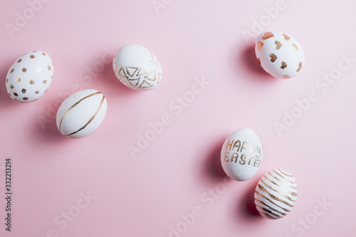 Easter eggs are hand-drawn on pink pastel background. Top view. Flat lay. Space for text. Minimalism and Happy Easter concept.