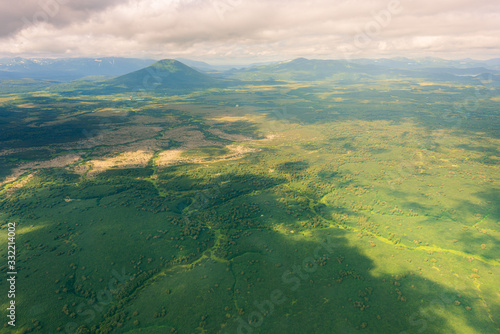 aerial view of Kamchatka volcanos, green valleys, snow and ice and the wonderful view of pure nature.
