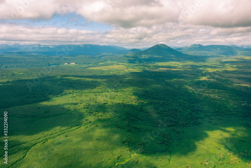 aerial view of Kamchatka volcanos, green valleys, snow and ice and the wonderful view of pure nature.