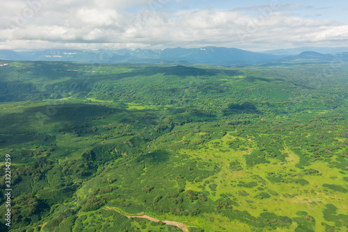 aerial view of Kamchatka volcanos, green valleys, snow and ice and the wonderful view of pure nature.