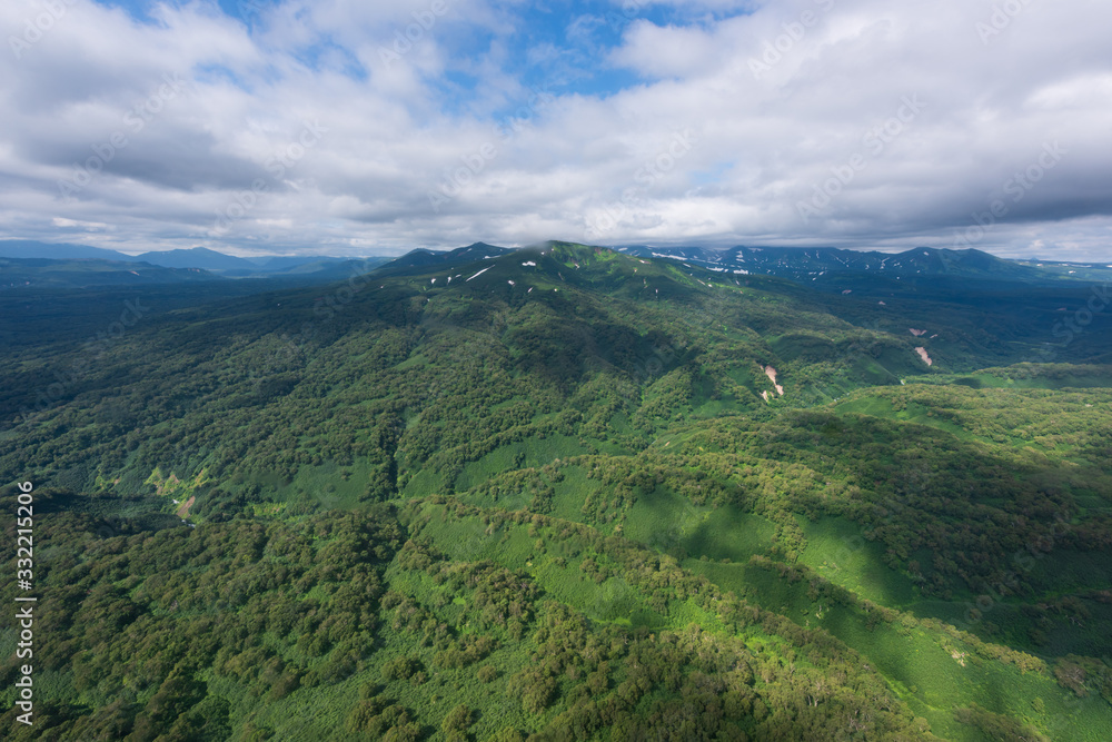 Obraz premium aerial view of Kamchatka volcanos, green valleys, snow and ice and the wonderful view of pure nature.