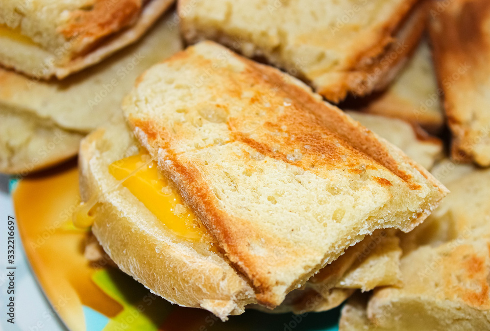 Hot toast with melted cheese for Breakfast made in a sandwich maker at home.
