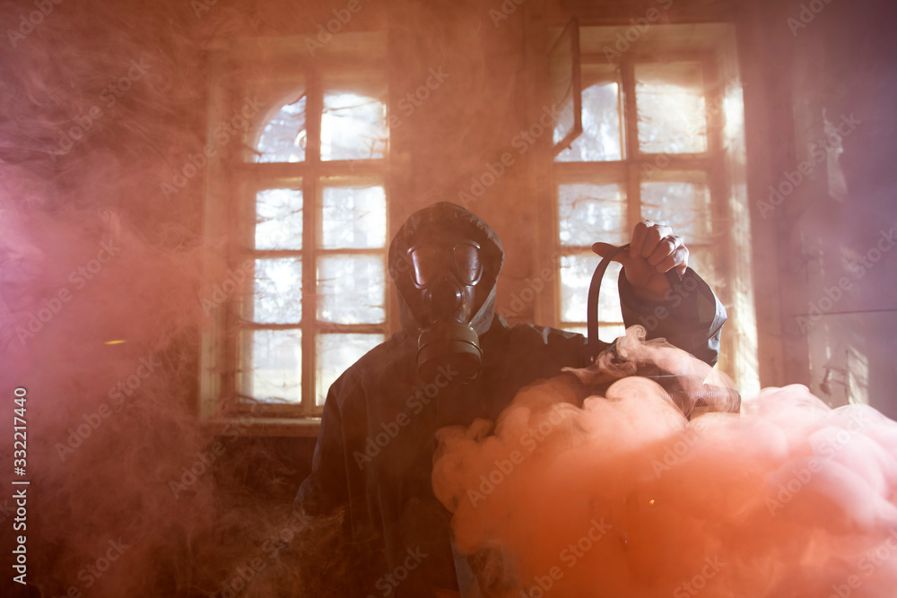 Dramatic portrait of a woman wearing a gas mask in a ruined building. Dramatic portrait of a woman wearing a gas mask in a ruined building.