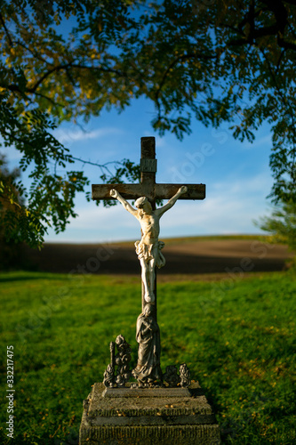 A roadside cross standing by the road among Moravian fields photo