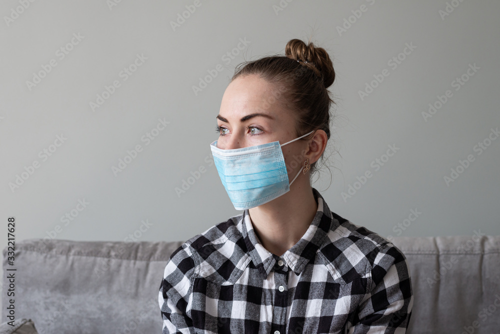 Girl with medical mask to protect her from virus. Coronavirus pandemic. Woman with mask standing . People being hospitalized, diagnosed, often put in carantine (isolation) to stop spreading Corona. Girl with medical mask to protect her from virus. Coronavirus pandemic. Woman with mask standing . People being hospitalized, diagnosed, often put in carantine (isolation) to stop spreading Corona.
