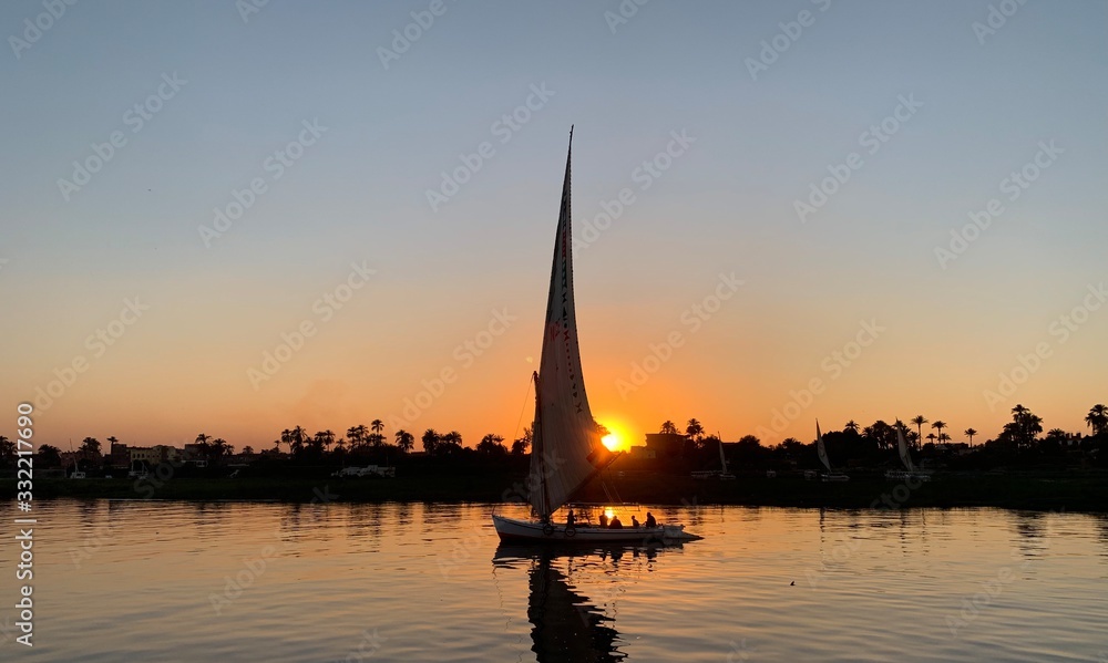 Fototapeta premium sailboat at sunset on river Nile egypt