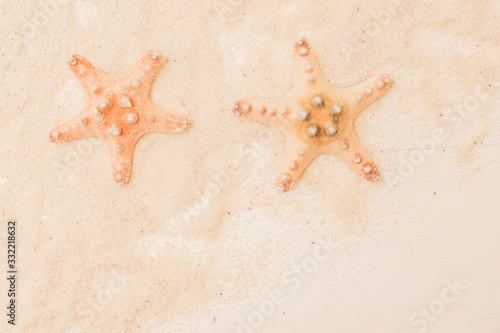 Flat lay composition with color starfish and sand