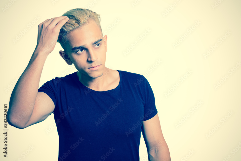 portrait of a young guy. straightens her hair. tinted portrait of a young guy. straightens her hair. tinted