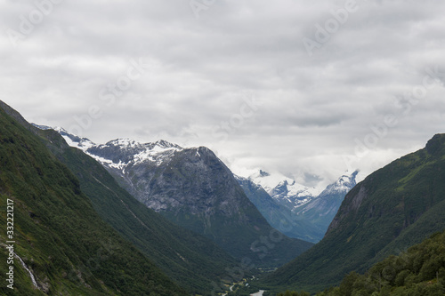 Nordic mountainous landscape, high mountains with snowy peaks, cloudy, alpine landscape
