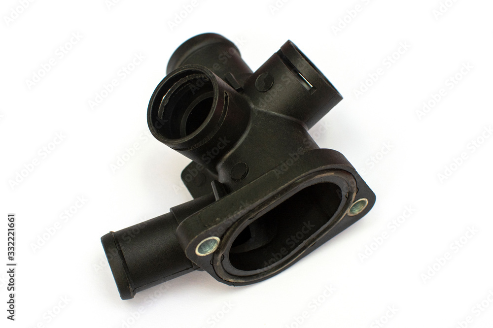 Thermostat housing. Spare part of the car engine cooling system on a white background. Thermostat housing. Spare part of the car engine cooling system on a white background.