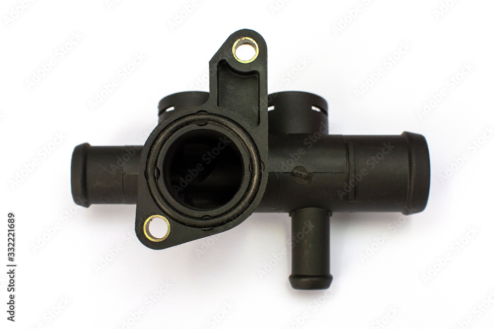 Thermostat housing. Spare part of the car engine cooling system on a white background. Thermostat housing. Spare part of the car engine cooling system on a white background.