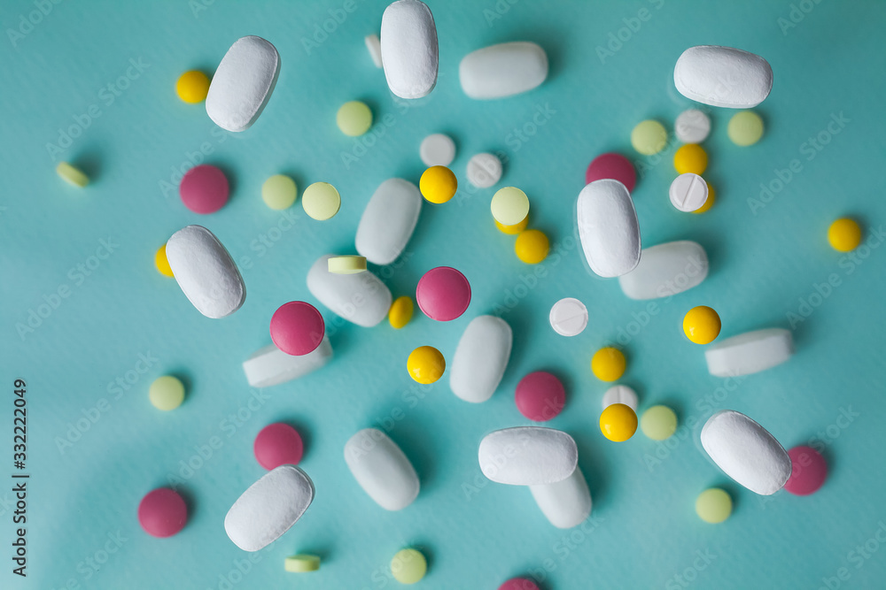 Pills for levitation. Pills on a blue background that fall down. Tablets. Medicine and health. Different types of pills