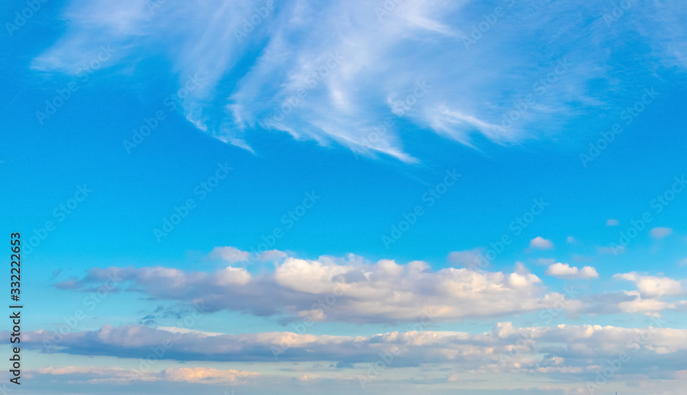 Light blue sky with white clouds of different strange shape_ Light blue sky with white clouds of different strange shape_
