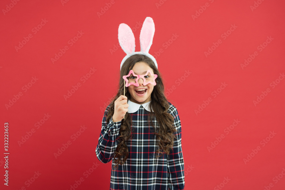 girl in Easter bunny during egg hunt. party and child concept. spring family holiday. little cute bunny. portrait of child with party glasses. having fun. funny kid wear bunny ears girl in Easter bunny during egg hunt. party and child concept. spring family holiday. little cute bunny. portrait of child with party glasses. having fun. funny kid wear bunny ears
