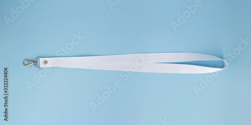 Blank white Bagde Lanyard lace mockup. Plain empty cotton band mock up isolated on blue background. photo