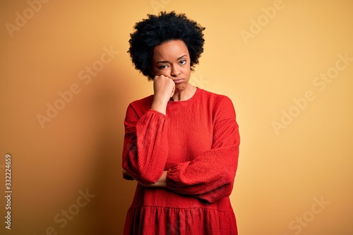 Young beautiful African American afro woman with curly hair wearing casual sweater thinking looking tired and bored with depression problems with crossed arms. © Krakenimages.com