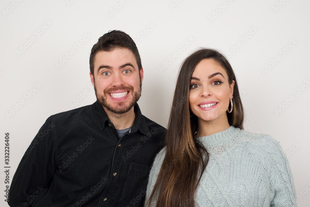 Young beautiful couple with an afro hairstyle having broad white smile being excited to meet Friends and go out to have a good day. Young beautiful couple with an afro hairstyle having broad white smile being excited to meet Friends and go out to have a good day.