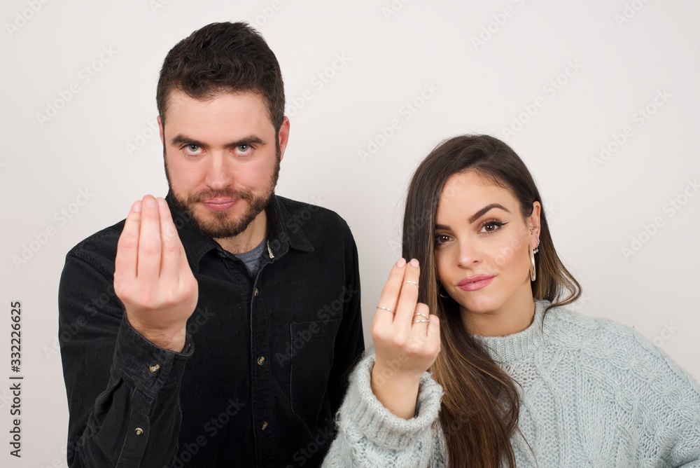 What the hell are you talking about. Shot of frustrated young European woman gesturing with raised hand doing Italian gesture, frowning, being displeased and confused with dumb question. What the hell are you talking about. Shot of frustrated young European woman gesturing with raised hand doing Italian gesture, frowning, being displeased and confused with dumb question.