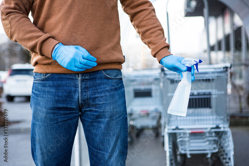 Disinfecting the handle of shopping basket. Coronavirus Epidemic Outbreak