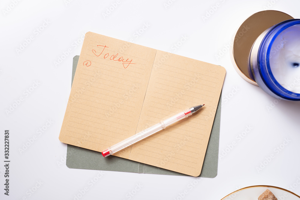 cup of coffee with diary, and care cosmetics around white background. life style flat lay cup of coffee with diary, and care cosmetics around white background. life style flat lay