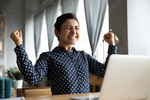 Billede på lærred Smiling Indian woman excited by good news, work success, received great shopping