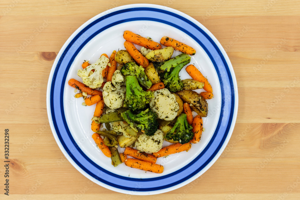 Fried vegetables on a plate. Broccoli, potatoes, cauliflower, green okra beans, carrots. Vegetarian food. Fried vegetables on a plate. Broccoli, potatoes, cauliflower, green okra beans, carrots. Vegetarian food.