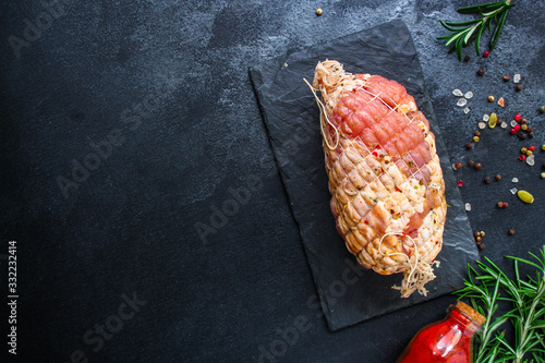 meat pork in roasting net (tasty and healthy raw meat food) menu keto or paleo concept. background. top view. copy space for text