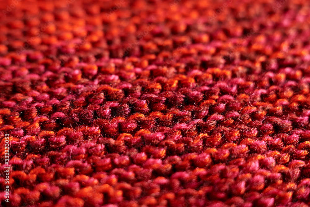 Knitted texture red color macro technique of scarf knitting with partial blur Knitted texture red color macro technique of scarf knitting with partial blur